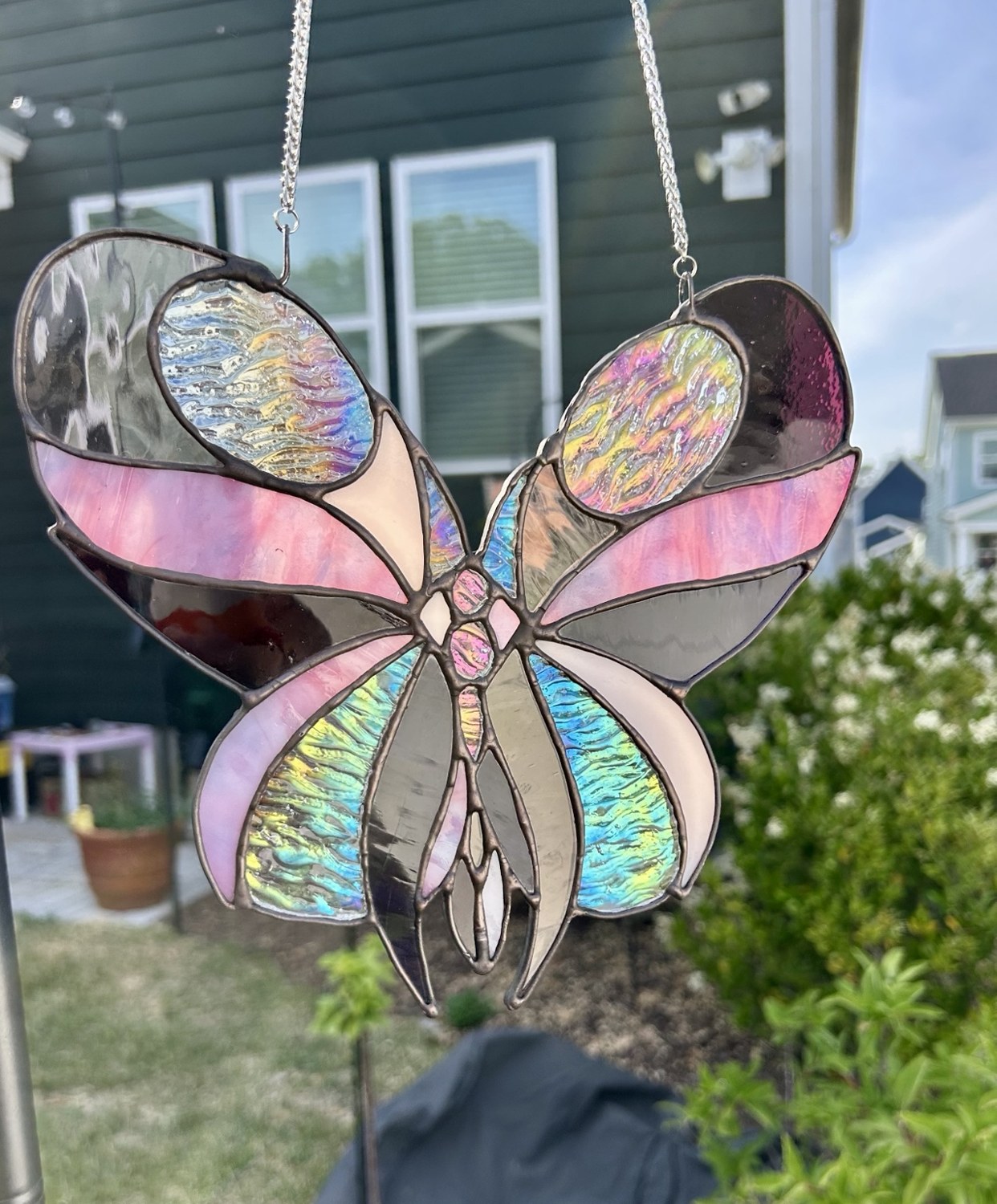 The same butterfly with its textured glass shimmering in rainbow colors