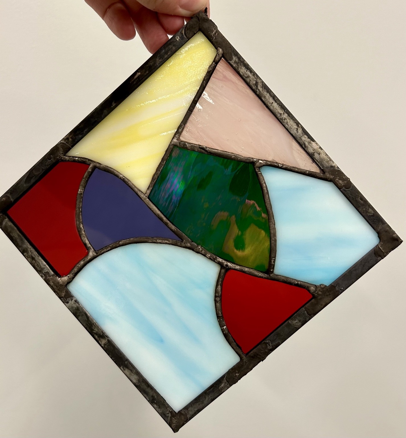 A diamond-shaped panel combining bold colors and sweeping curves.