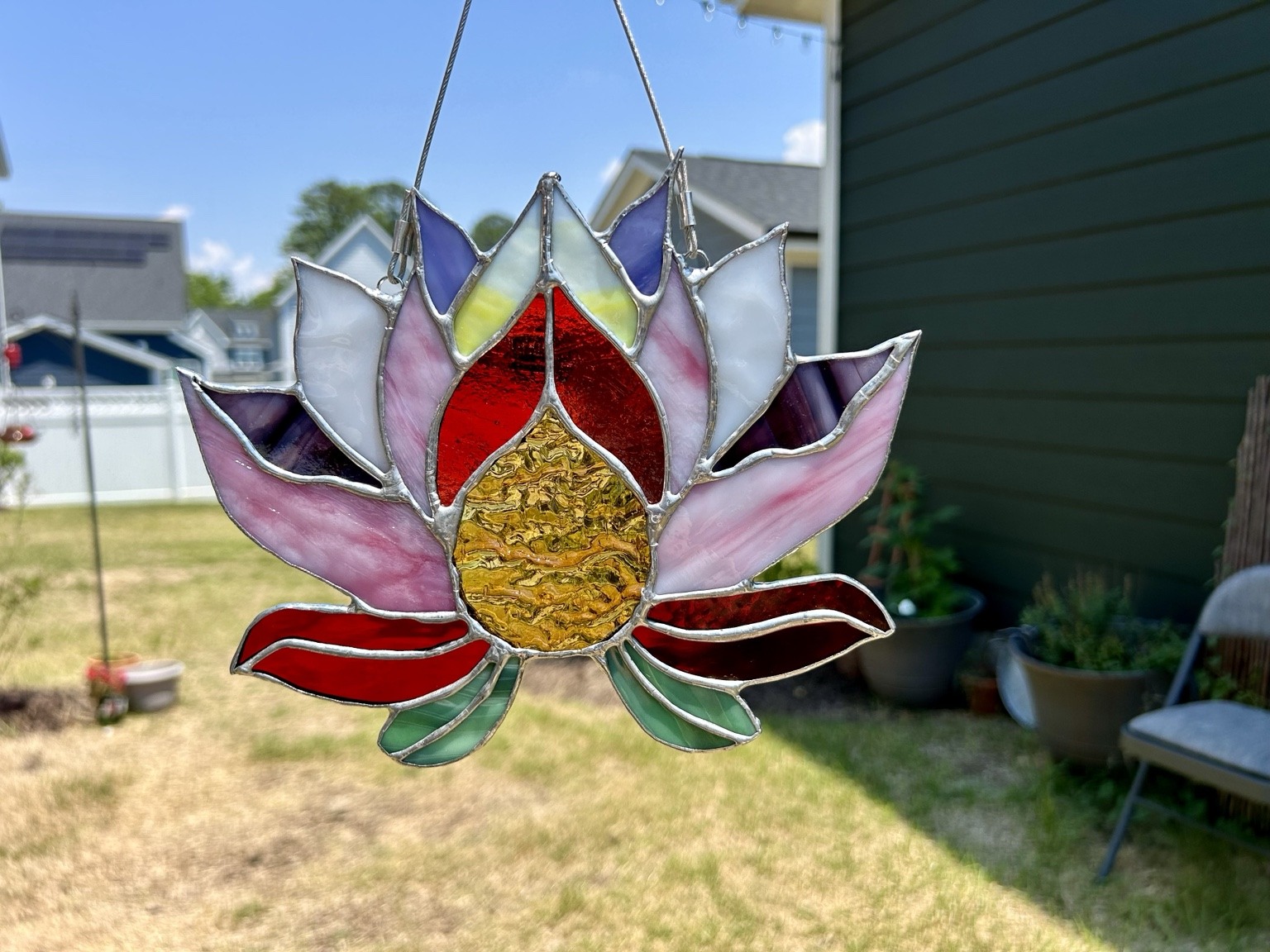 Pink, purple and red petals around a golden textured center.