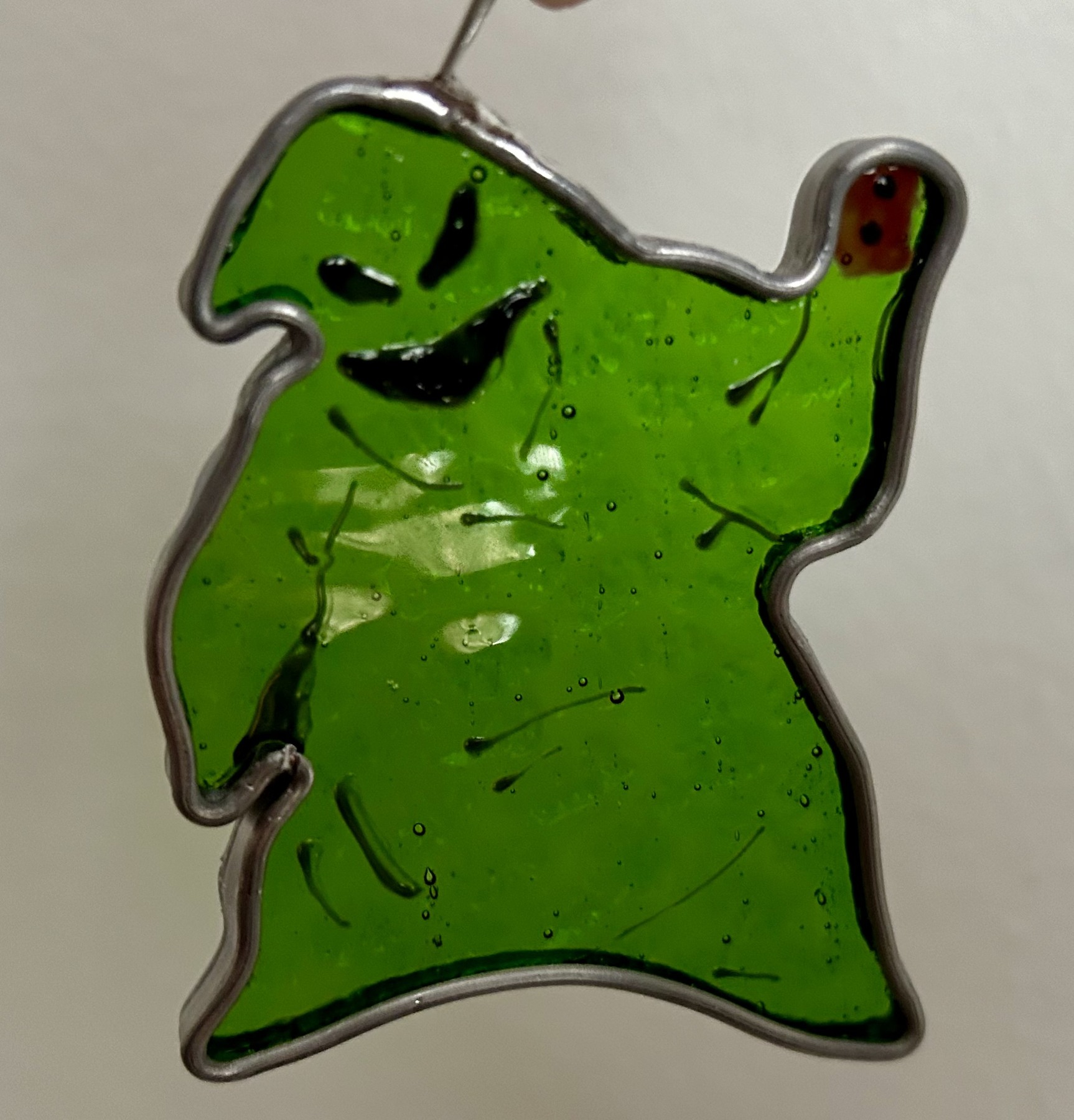 Bright green glass with a playful face and flowing silhouette.