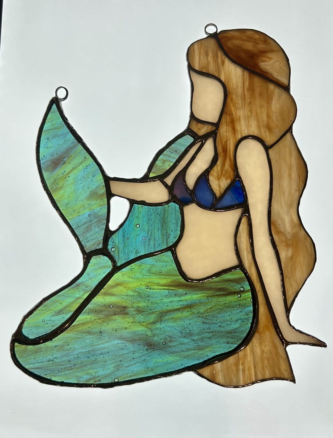 Another view of the same mermaid, highlighting the texture of the green tail.