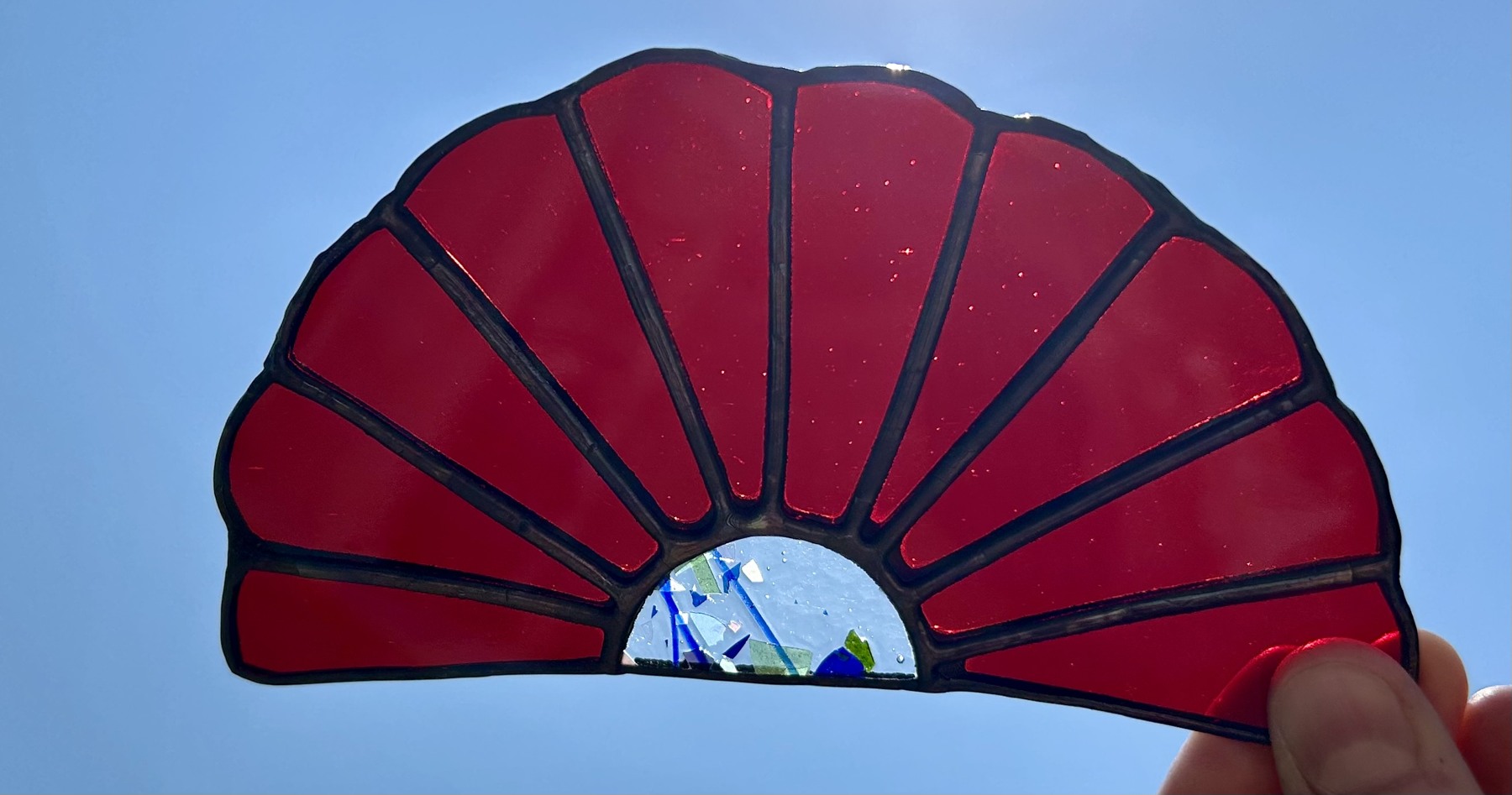 Rich red glass with a small confetti-glass center.